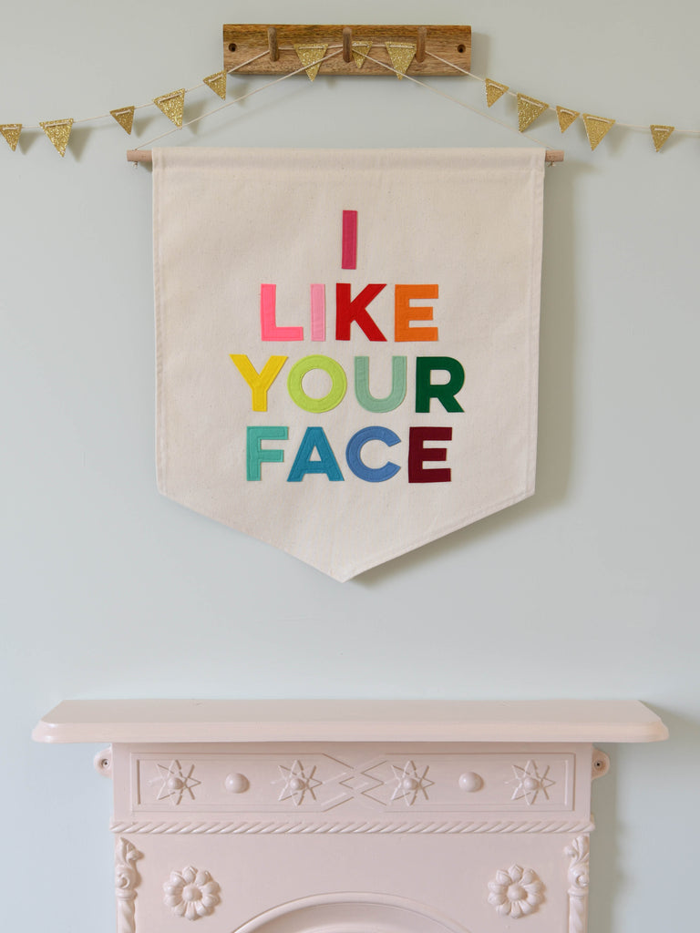 Fabric banner with the words I Like Your Face sewn on in bright coloured felt.