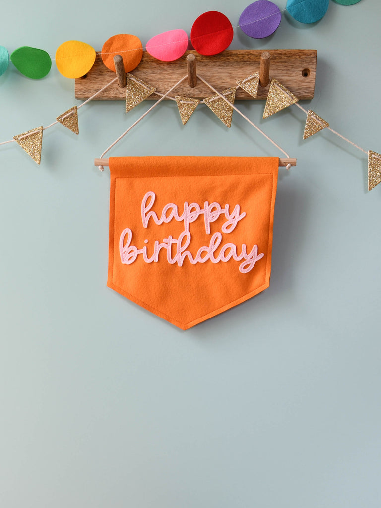 mini banner with happy birthday sewn on in cursive text.