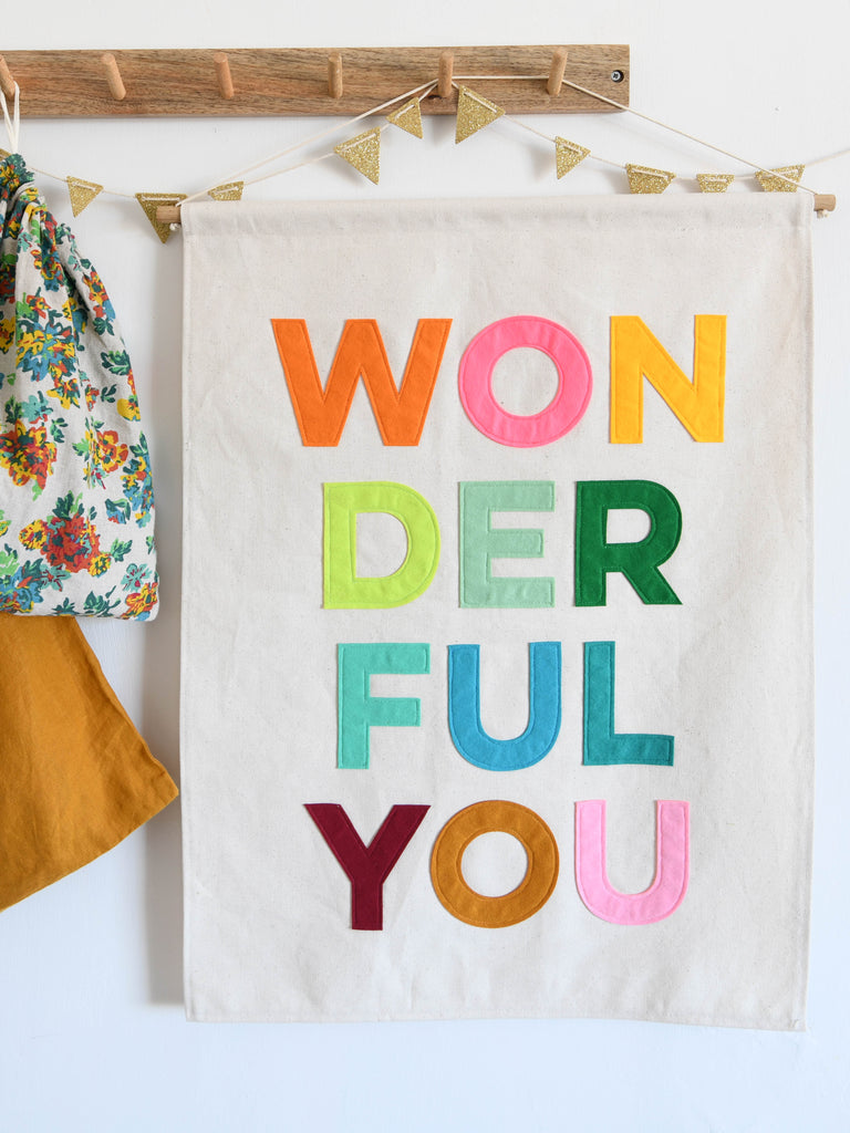 canvas wall banner with felt letters sewn on spelling WONDERFUL YOU.