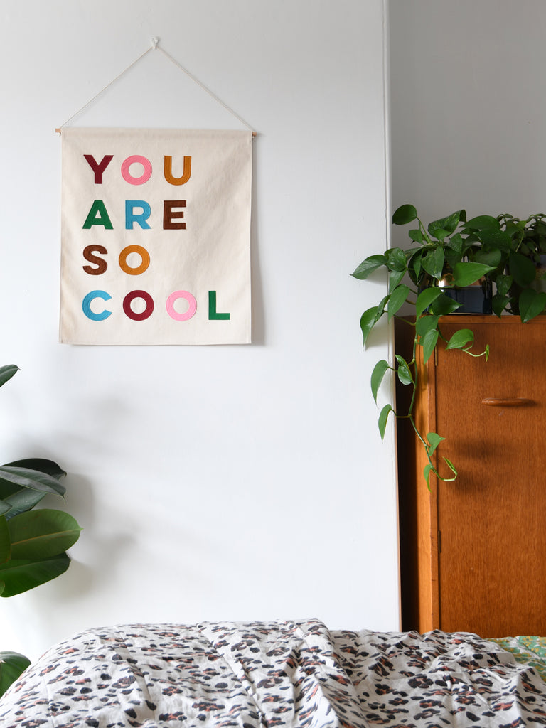 canvas wall banner with the words you are so cool sewn on in felt letters.