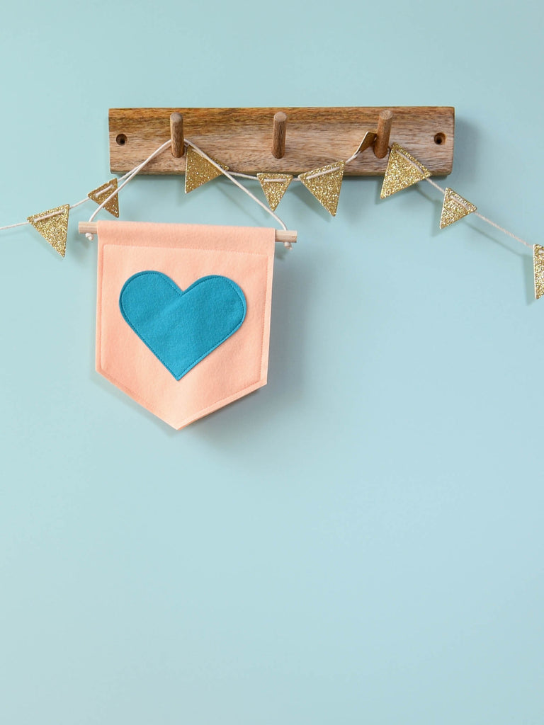 peach banner with blue heart.