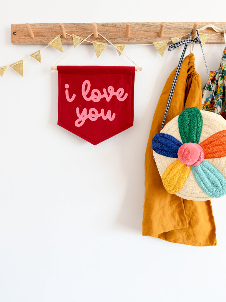 i love you mini felt wall banner hung on hook.