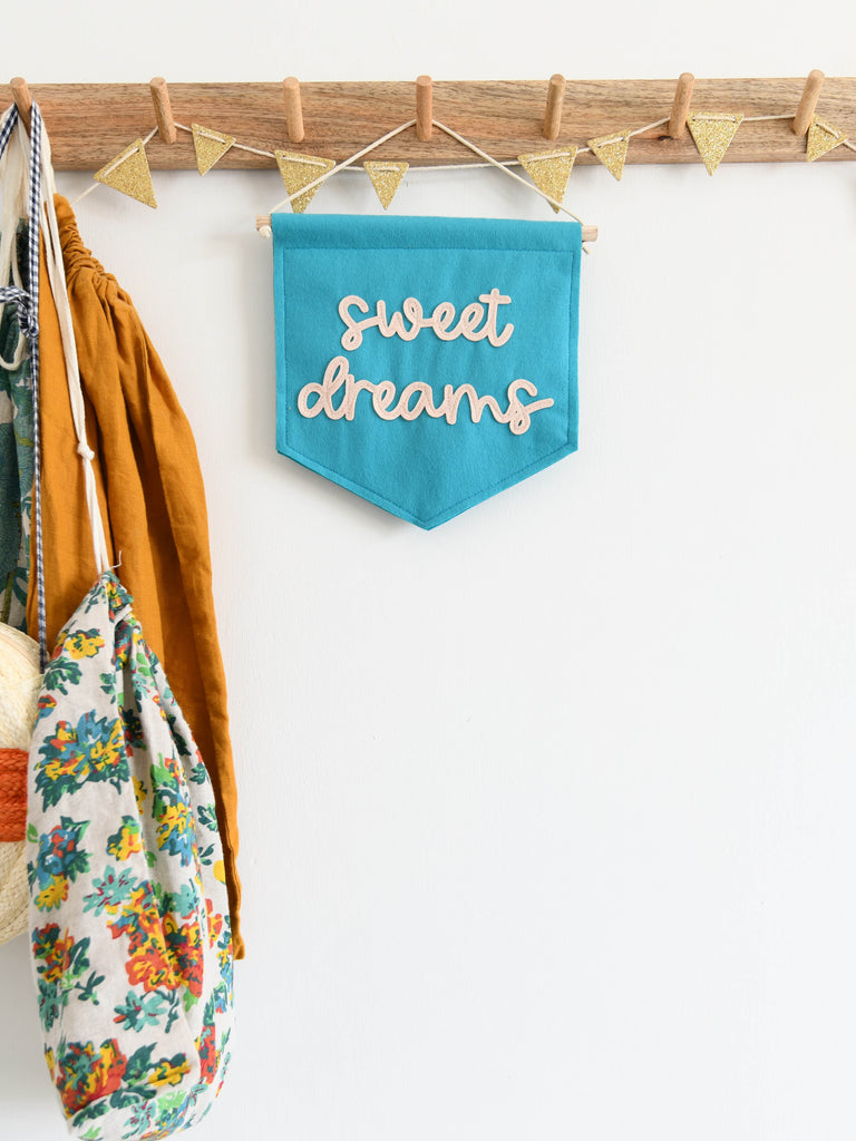 min blue felt banner with sweet dreams sewn on for kids room decor.