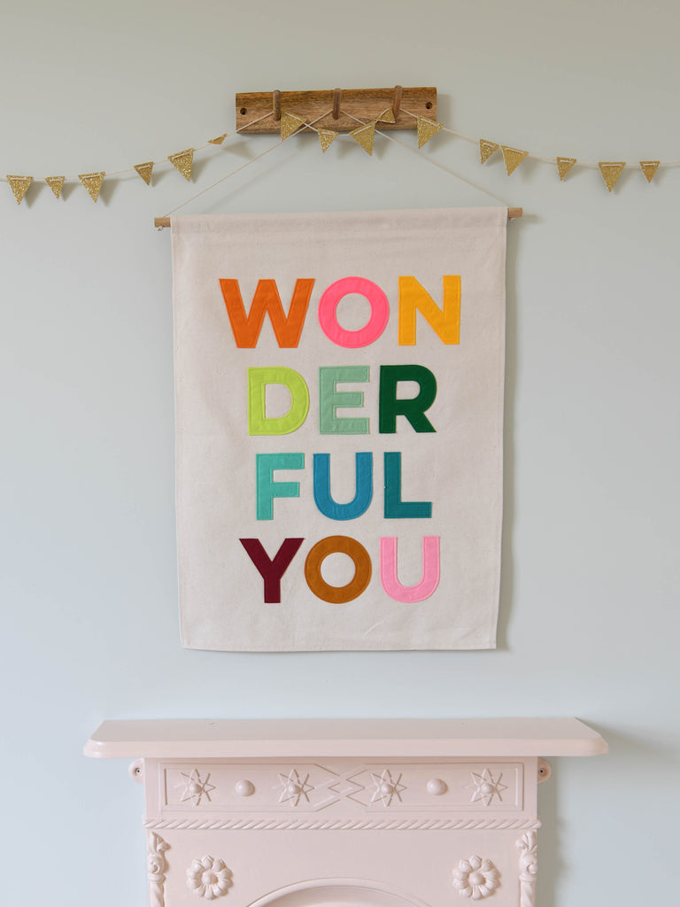 fabric wall banner with wonderful you sewn on in brightly coloured felt letters.